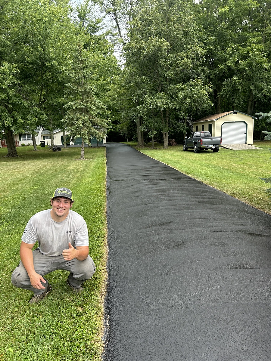 Hunter Cassel with a freshly sealed Northern Ohio driveway